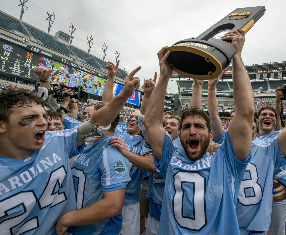 North Carolina's Steve Pontrello holds the NCAA Division I men's lacrosse trophy after a 14-13 win over Maryland at Philadelphia on Monday. The game drew 26,749 fans.