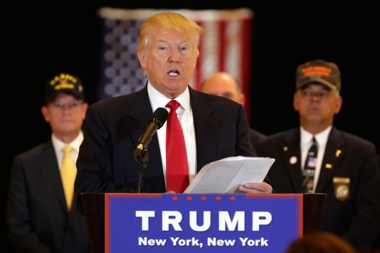 Republican presidential candidate Donald Trump reads from a list of donations to veteran's groups, during a news conference in New York Tuesday.