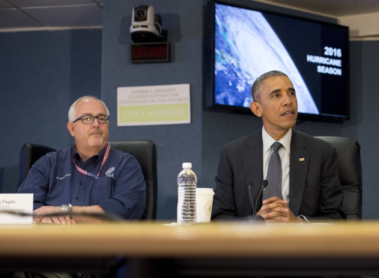 President Barack Obama visits the headquarters of the Federal Emergency Management Agency in Washington on Tuesday to receive a hurricane preparedness briefing. At left is FEMA Administrator Craig Fugate.