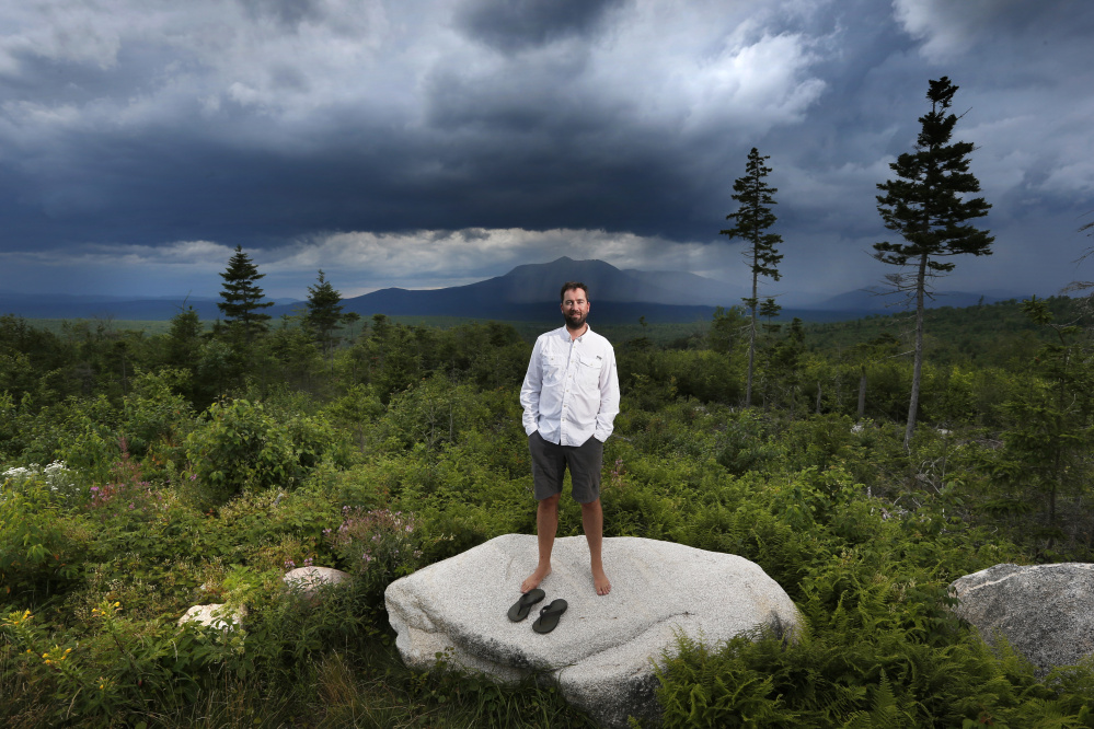 Lucas St. Clair poses on land proposed for a national park in Penobscot County. Mount Katahdin, the state's highest peak, can be seen in the background. St. Clair manages a nonprofit foundation set up to promote the creation of a park on about 70,000 acres owned by his mother, Burt's Bees founder Roxanne Quimby.