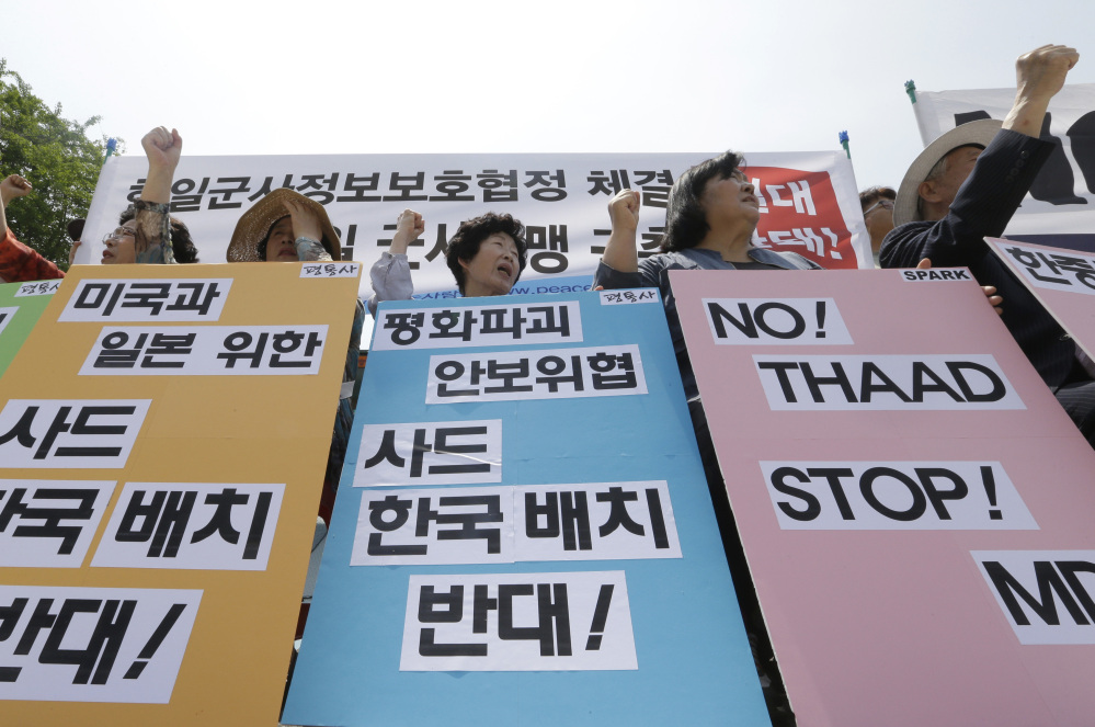 South Korean protesters stage a rally denouncing the United States, South Korean and Japanese governments' missile policies on North Korea in Seoul, South Korea, Tuesday.
