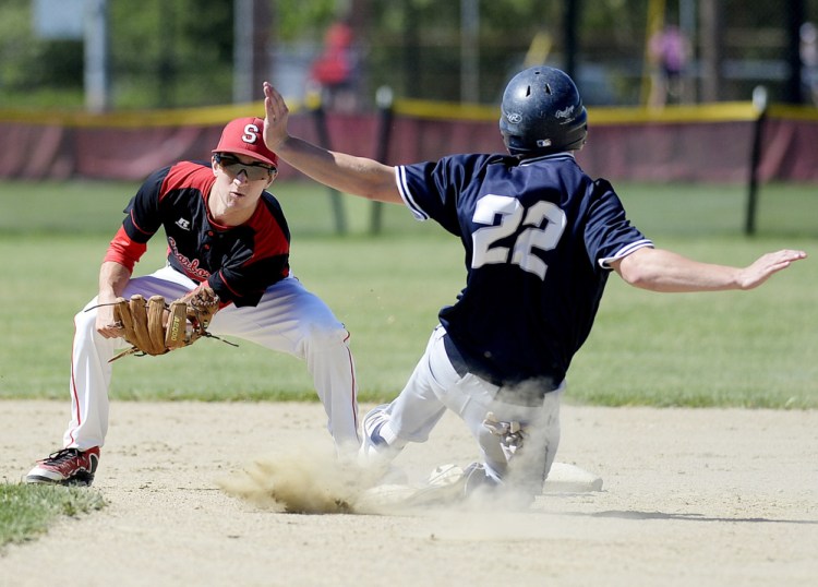Portland's Jacob Knop tries to elude the tag by Scarborough's Nick Lorello in Tuesday's SMAA game in Scarborough. The Red Storm rallied for a 4-3 win.