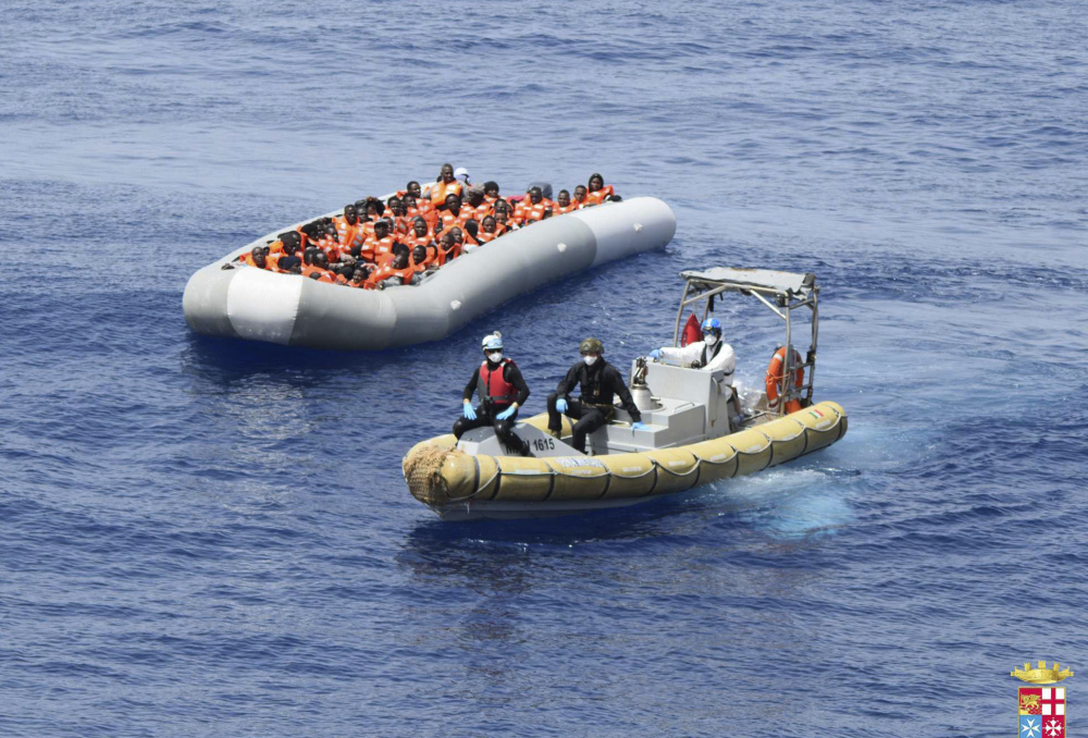 Migrants are shown being rescued in the Mediterranean Sea. The staggering death toll of at least 1,083 migrants over the past week occurred as barely seaworthy vessels loaded with passengers foundered and sank despite calm seas and sunny skies.