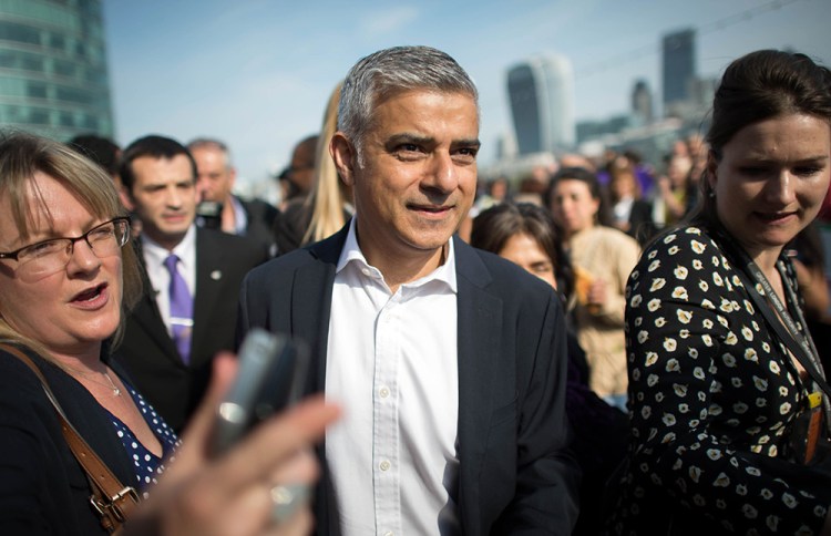 Newly elected London Mayor Sadiq Khan is greeted by well wishers outside City Hall in London, on his first day as mayor on Monday. Jonathan Brady/PA via AP