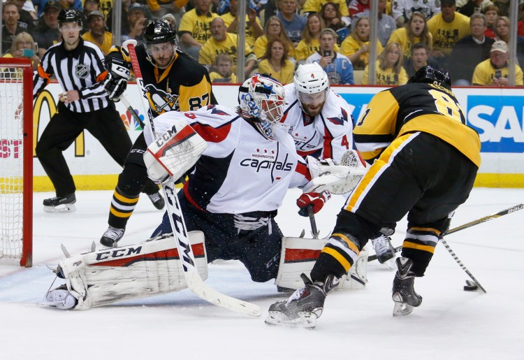 Pittsburgh's Phil Kessel, right, shoots and scores on Washington goalie Braden Holtby during the second period Tuesday.   The Associated Press
