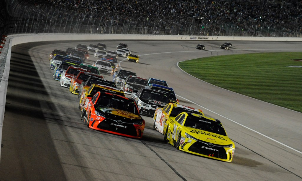 Sprint Cup Series driver Martin Truex Jr. (78), left, and Sprint Cup Series driver Matt Kenseth (20), right, lead the pack during a Sprint Cup Series race at Kansas Speedway in Kansas City, Kan., Saturday, May 7, 2016. The Associated Press