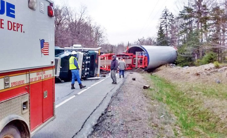 A loaded truck hauling a windmill base from the Quebec border to a wind project in Bingham rolled over Monday when the driver lost control on a corner in Johnson Mountain Township. Photo courtesy of West Forks Volunteer Fire Department
