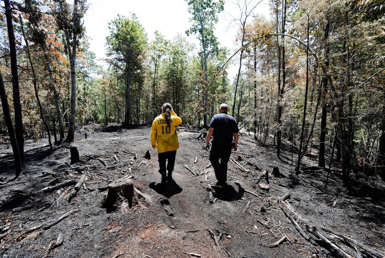 Lebanon Fire and EMS Chief Dan Meehan, right, and firefighter/EMT Windy Rudnicki survey the scene of a recent forest fire Monday in Lebanon, looking for hot spots.
Joel Page/Staff Photographer