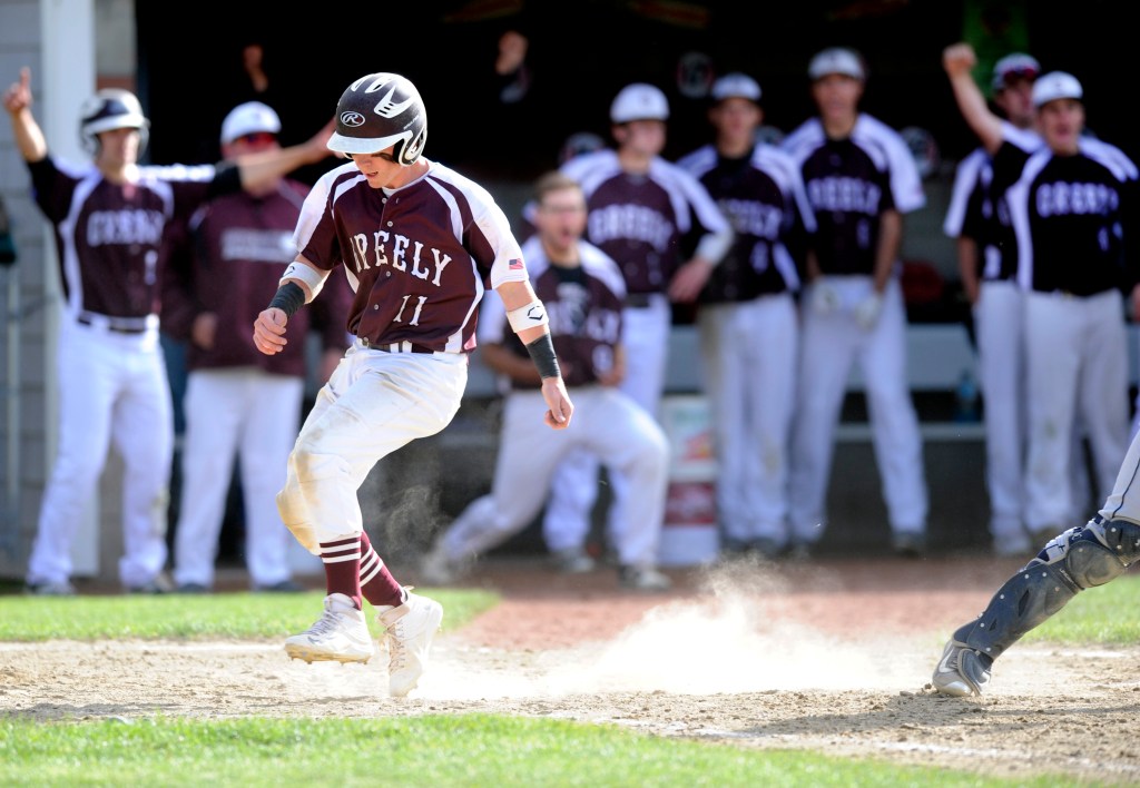 Greely teammates celebrate as Justin Leeman crosses the plate in the sixth inning to give the Rangers a 2-0 lead. 
Derek Davis/Staff Photographer