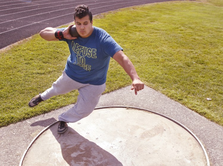 Dan Guiliani practices shot put at South Portland High School on Thursday. With a throw in May, he broke the New England record by almost 4 feet.
Gregory Rec/Staff Photographer)