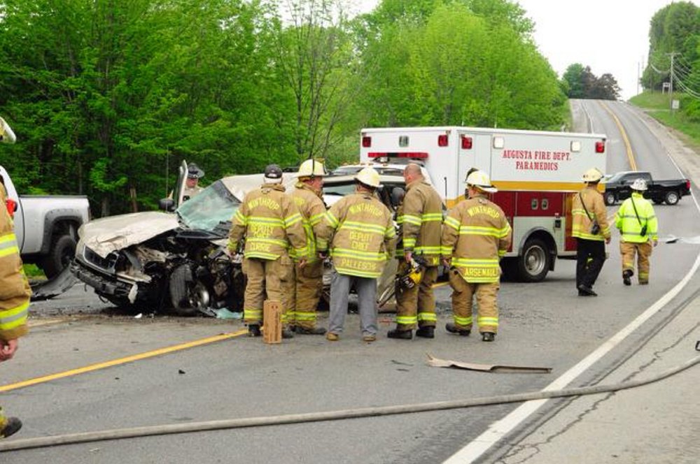 Firefighters work at the scene of a two-vehicle crash on U.S. Route 202 in Manchester near Pelton Hill Road. 
