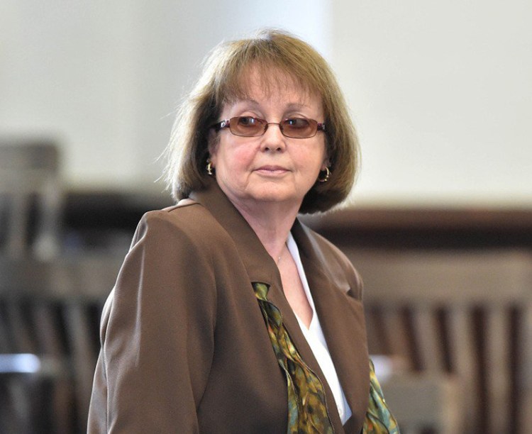 Claudia Viles stands as the jury leaves the courtroom to deliberate on the 13 charges against her Wednesday morning, the third day of her trial in Somerset County Superior Court in Skowhegan. 