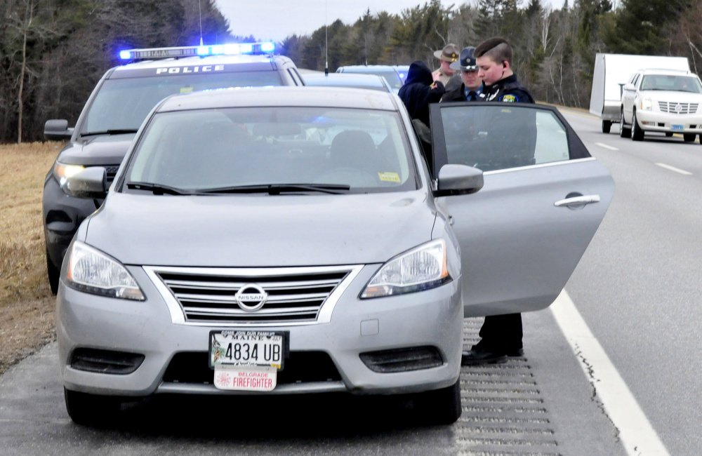 Skowhegan police Detective Katelyn Treylino searches the contents of a car she pulled over on Interstate 95 in Newport after a chase that began in Skowhegan in February and resulted in the arrest of Ryan Galouch, a Belgrade firefighter at the time.