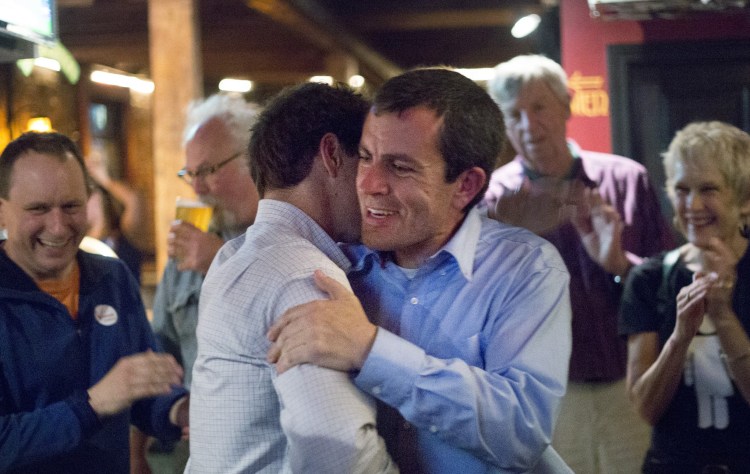 Ben Chipman, right, is greeted by state Sen. Justin Alfond at Brian Boru in Portland on Tuesday night as they celebrate Chipman's win in the Senate District 28 primary.
Derek Davis/Staff Photographer
