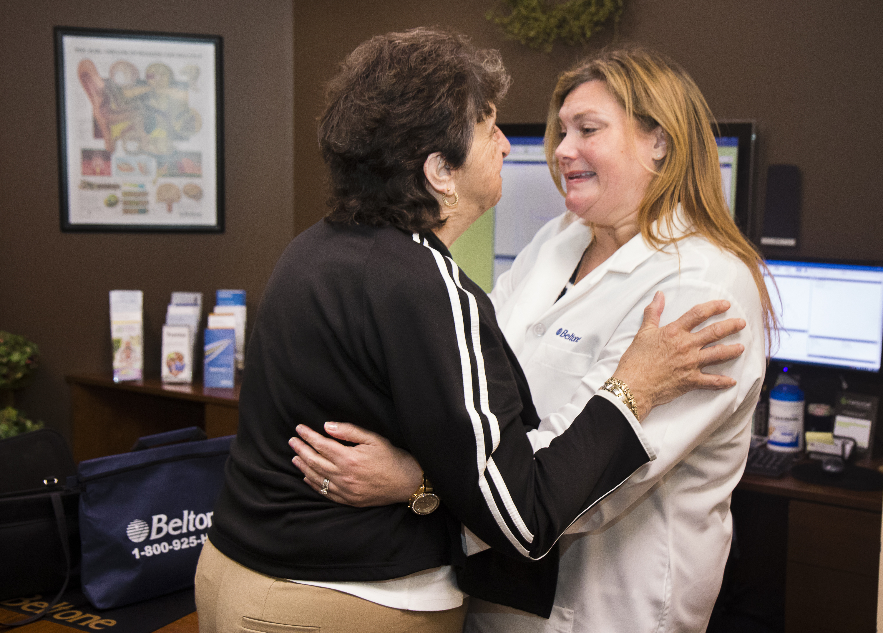 Pat Linhares hugs Karen Kirtani, a hearing aid specialist at Belltone Hearing Aid Center in Scarborough. Carl D. Walsh/Staff Photographer