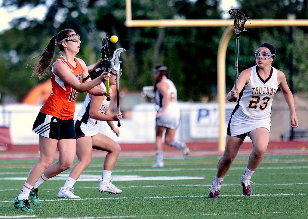 Taylor Turgen of Biddeford, at left, passes the ball upfield past Thornton Academy's Addy Paradis and Rachel Richard during a Class A South girls' lacrosse quarterfinal, on Wednesday.
Gabe Souza/Staff Photographer