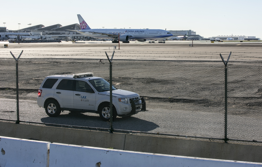 A security vehicle patrols the perimeter of the Los Angeles International Airport.