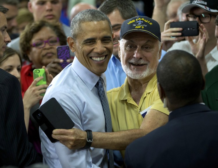 President Barack Obama greets a guest in the audience after speaking at Concord Community High School in Elkhart, Ind., on Wednesday.