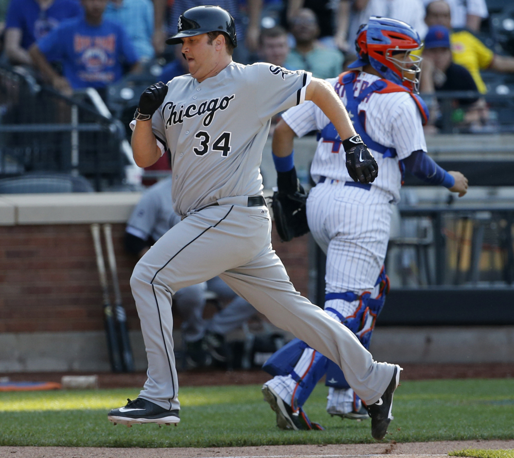 Pitcher Matt Albers of the White Sox scores on Jose Abreu's 13th-inning sacrifice fly to put Chicago ahead in a 2-1 win over the Mets at New York.