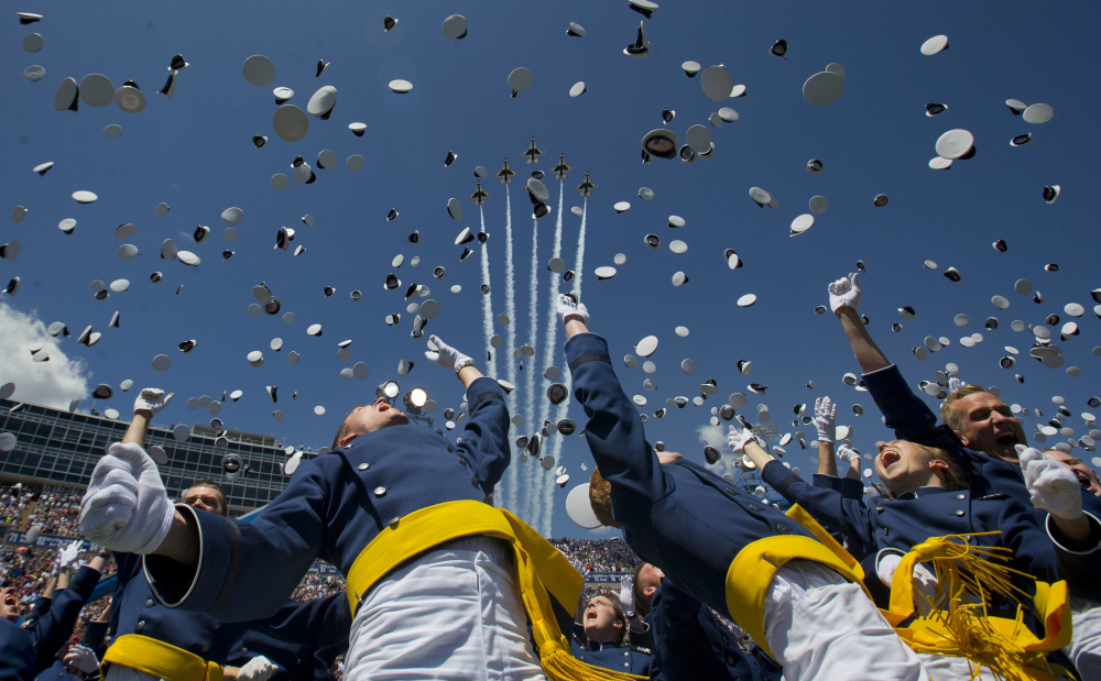 The Air Force Thunderbirds fly overhead as cadets celebrate by tossing their hats after graduation at the Air Force Academy on Thursday in Colorado Springs, Colo. One of the jets crashed after a flyover of the commencement, attended by President Obama.