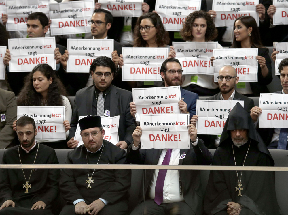 Guests hold posters reading "RecognitionNow says Thank you" at the German Parliament, which voted to label the killings of Armenians by Ottoman Turks as genocide.