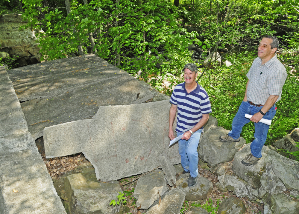 Bob Harris, left, and Jerry Bley stand on top of the washed-out dam on Thursday on Mill Stream in Readfield. They're part of a group planning to add trails and other improvements aimed at providing greater public access to the area.
