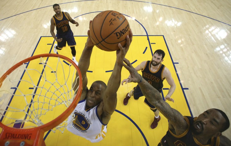 Golden State forward Andre Iguodala dunks against the Cavaliers in the first half. Iguodala finished with 12 points, seven rebounds and six assists.
