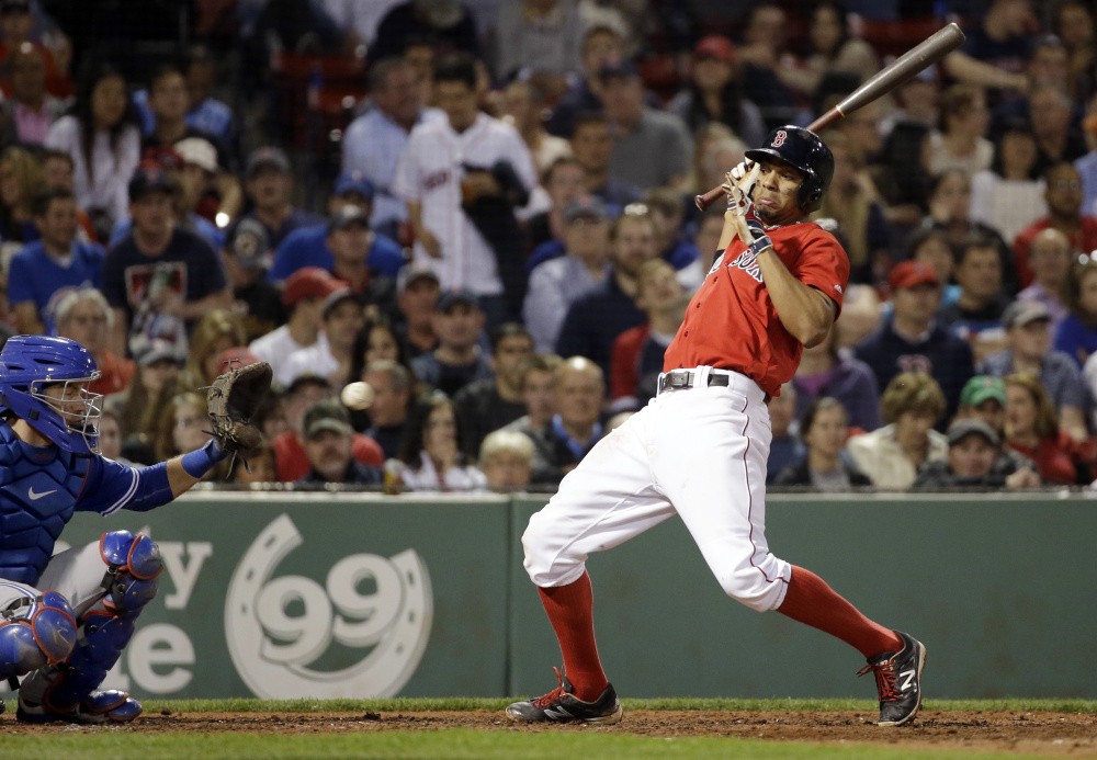 Boston's Xander Bogaerts leans back to avoid a pitch as Blue Jays catcher Josh Thole pulls it in.