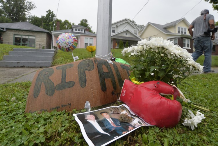A small memorial sits in front of the boyhood home of Muhammad Ali on Saturday in Louisville Ky.