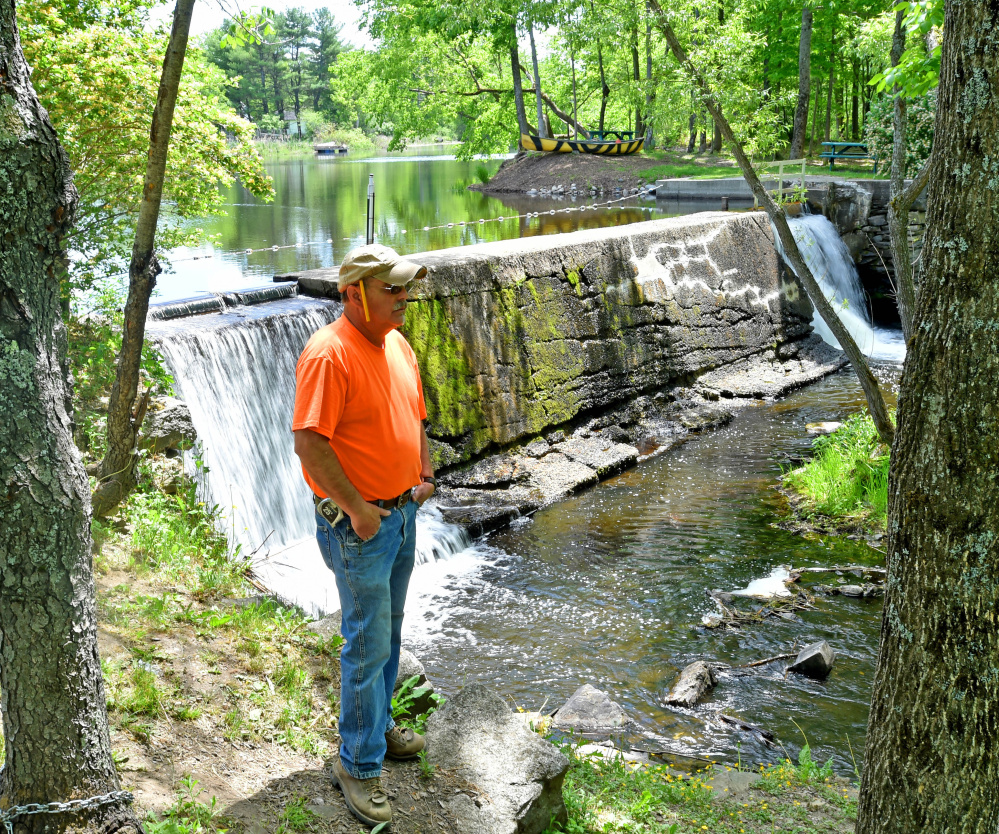 Standing by Mill Pond and Mill Stream Dam in Vassalboro on Wednesday, Dwayne Rioux shares his concern that removal of dams on Outlet Stream will let non-native fish species upstream. Other residents worry about the effect on pond wildlife.
