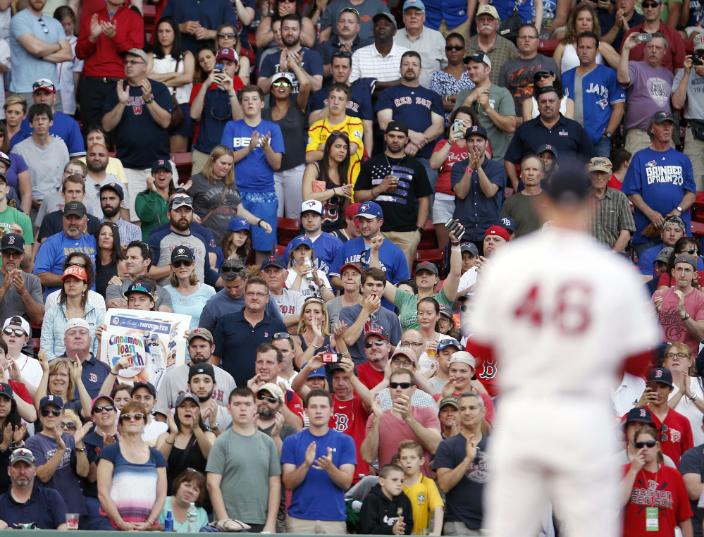 The crowd stands and cheers as Red Sox closer Craig Kimbrel prepares to deliver a pitch Saturday in Boston. Kimbrel earned his 13th save and Boston snapped a three-game losing streak with a 6-4 win over Toronto.