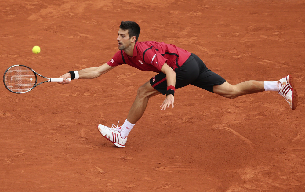 Serbia's Novak Djokovic stretches to return the ball to Britain's Andy Murray during their final match of the French Open tennis tournament at the Roland Garros stadium, Sunday, June 5, 2016 in Paris.