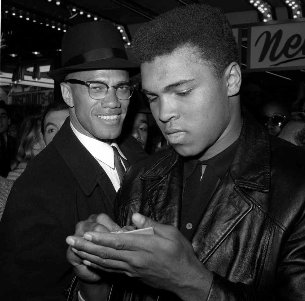 Muhammad Ali and Malcolm X leave the Trans-Lux Newsreel Theater in New York City in 1964 after watching a screening of Ali's title fight with Sonny Liston in Miami Beach.