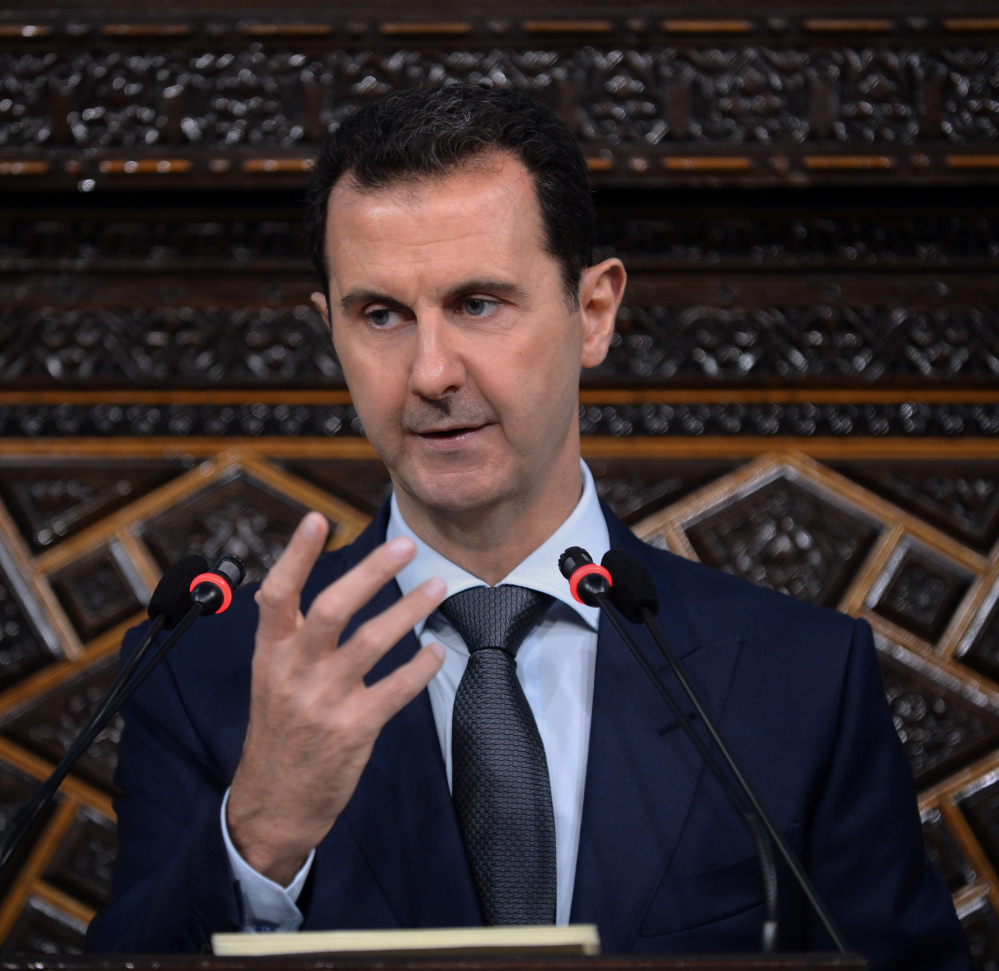 President Bashar Assad delivers tough talk to Syria's parliament in Damascus on Tuesday.
