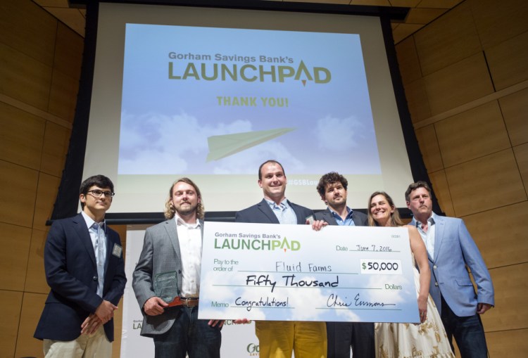 Tyler Gaudet of Fluid Farms holds the $50,000 prize after winning the Gorham Savings Bank LaunchPad live-pitch competition in 2016.
