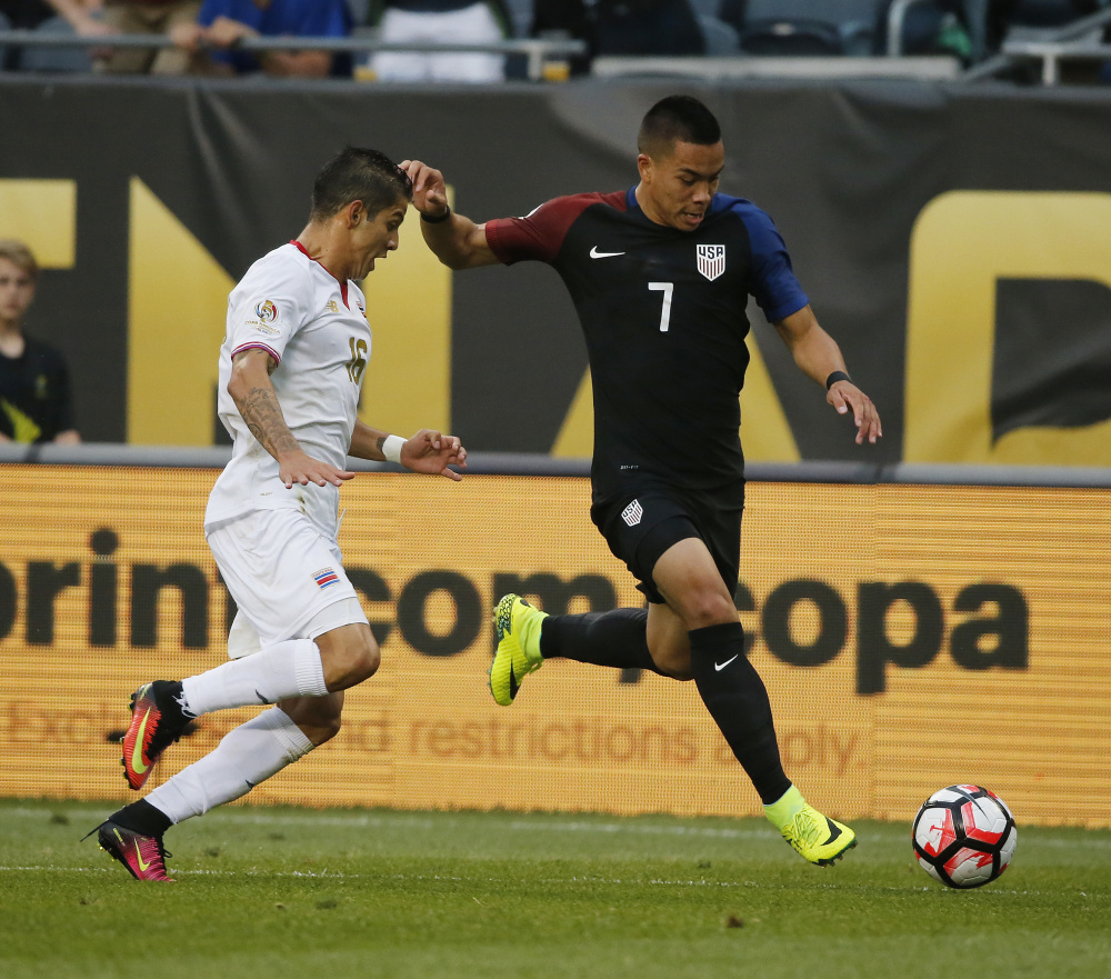 Bobby Wood of the United States, right, controls the ball against Cristian Gamboa of Costa Rica during their Copa America game Tuesday night in Chicago. Wood scored in the first half, part of a key 4-0 victory.
