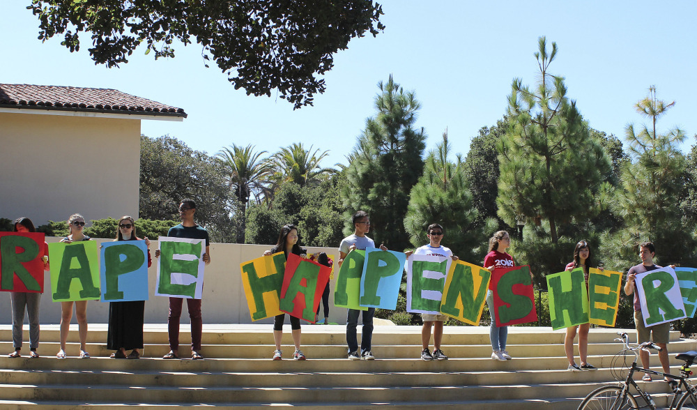 Students hold up a sign about rape during New Student Orientation in September on the Stanford University campus. Stanford considers itself a national leader on preventing and handling sexual assaults, but students have complained that the school isn't doing enough.