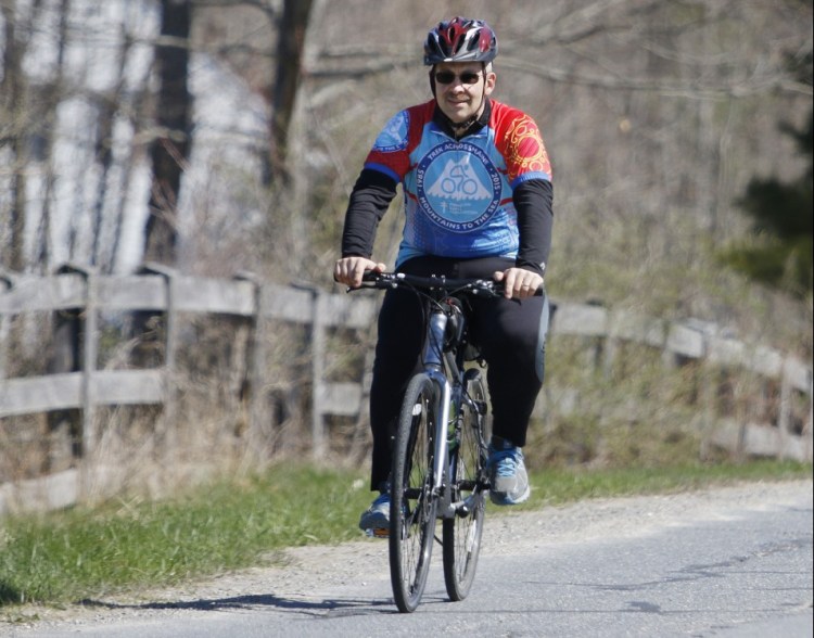 Andy Bourassa prepares for a Trek Across Maine training ride in April near his home in Winslow. Bourassa weighed 387 pounds before bariatric surgery suggested by his doctor and encouraged by his workplace wellness coach at Duratherm Window Corp. in Vassalboro.