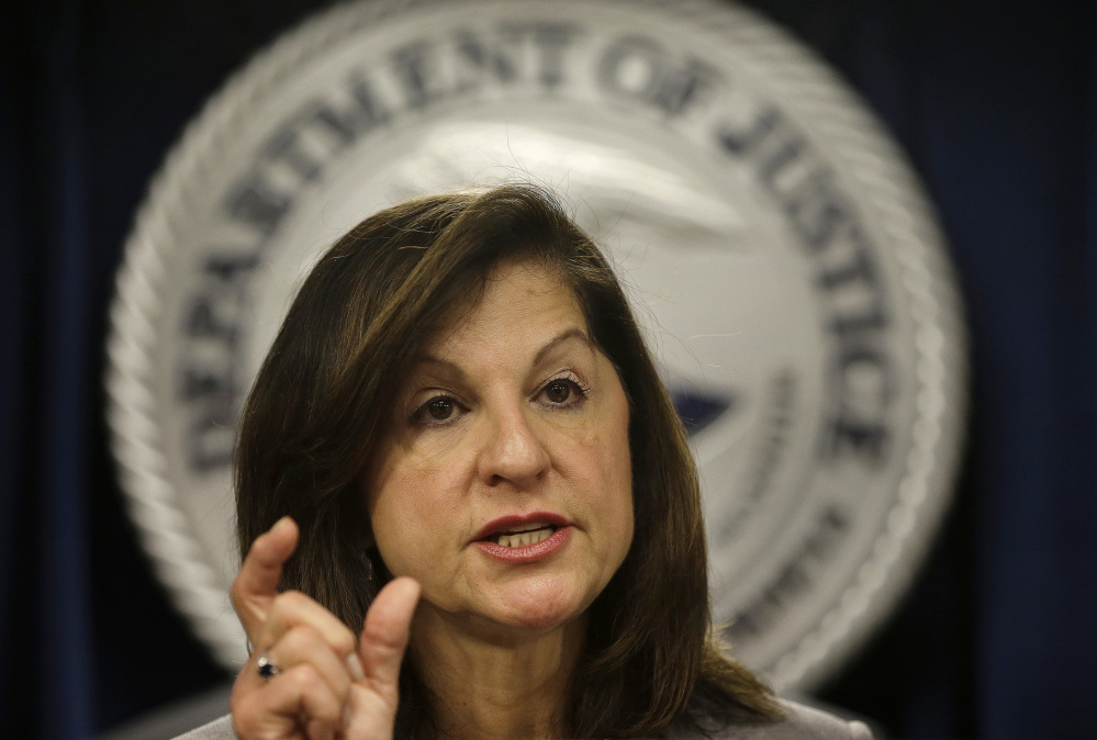 U.S. Attorney Carmen Ortiz responds to questions from reporters during a news conference at the federal courthouse Thursday in Boston, where law enforcement officials announced that more than 60 alleged gang members from Massachusetts have been charged with drug, weapons and racketeering offenses.