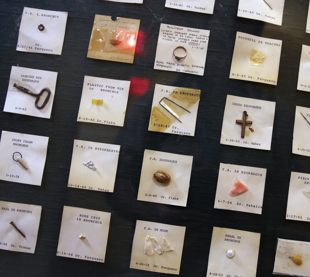 A variety of items ingested by children, from a sardine can key to a crucifix, are displayed at Boston Children's Hospital Wednesday as a gruesome reminder of an avoidable danger.