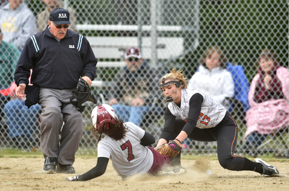 Winslow's Paige Veilleux (17) tags out Ellsworth's Shelby Cote (7) at third base in a Class B North quarterfinal game Thursday in Winslow.