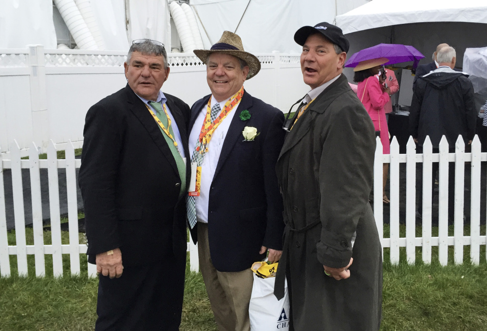 The Kerr brothers of Old Orchard Beach – from left, Mike, George and Jamie – pose at Pimlico Race Course in Baltimore, where the horse they partly own, Exaggerator, won the Preakness last month. The Kerrs first got involved in horse racing in the early 1980s and currently own 22 horses.