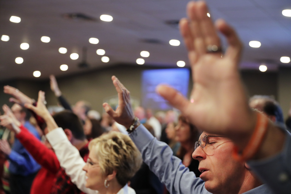 Parishioners pray during a service at the Christian Fellowship Church in Benton, Ky. Religious conservatives could once count on their neighbors to at least share their view of marriage, but public opinion on same-sex relationships has changed.