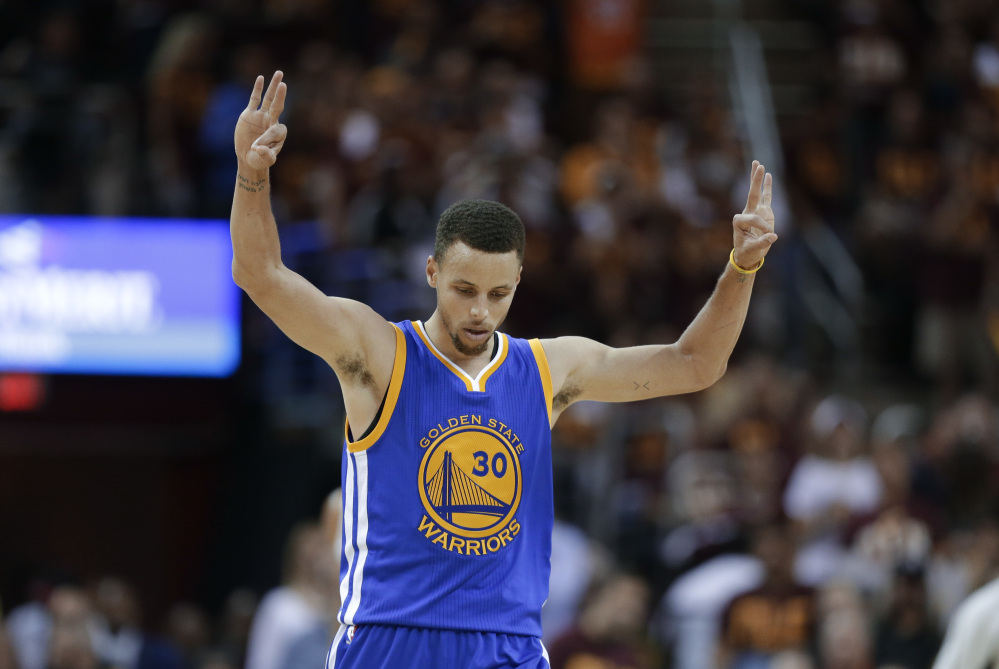 Warriors guard Stephen Curry celebrates a basket against the Cavaliers in the second half of Game 4 of the NBA Finals in Cleveland on Friday.