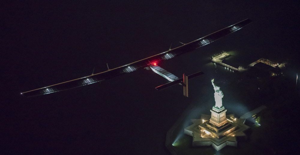 Solar-powered Solar Impulse 2, piloted by Swiss adventurer Andre Borschberg, flies over the Statue of Liberty.