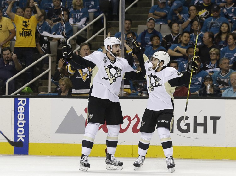 Penguins defenseman Brian Dumoulin, left, is congratulated by Conor Sheary after scoring in the first period of Game 6 of the Stanley Cup finals. The Penguins clinched the championship with a 3-1 victory.