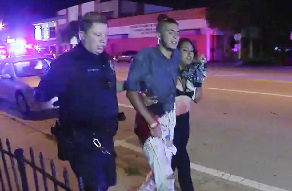 An injured man is escorted out of the Pulse nightclub after a shooting rampage, Sunday morning June 12, 2016, in Orlando, Fla. A gunman wielding an assault-type rifle and a handgun opened fire inside a crowded gay nightclub early Sunday, killing at least 50 people before dying in a gunfight with SWAT officers, police said. It was the deadliest mass shooting in American history. (AP Photo/Steven Fernandez)