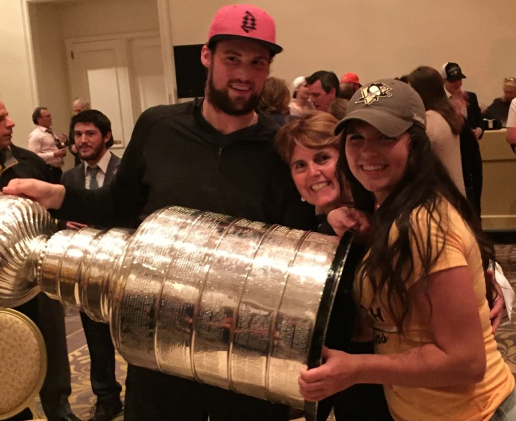 Brian Dumoulin celebrates with the Stanley Cup alongside his mother, Deborah, center, and his sister, Katherine. Dumoulin and the Penguins wrapped up the title Sunday.