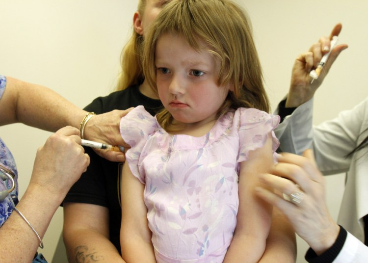 Holly Ann Haley gets vaccinations at the doctor's office in Berlin, Vt., in 2012. The rate of Maine parents who choose not to have their children immunized remains among the nation's highest.