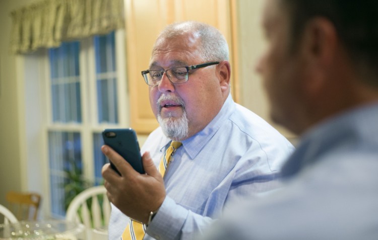 State Rep. Mark Dion checks for Senate District 28 election results on his phone Tuesday evening, accompanied by campaign manager Dennis Hersom, right.
Derek Davis/Staff Photographer